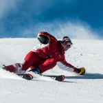 a snowboarder wearing snowboard gear and snowboarding on the snow