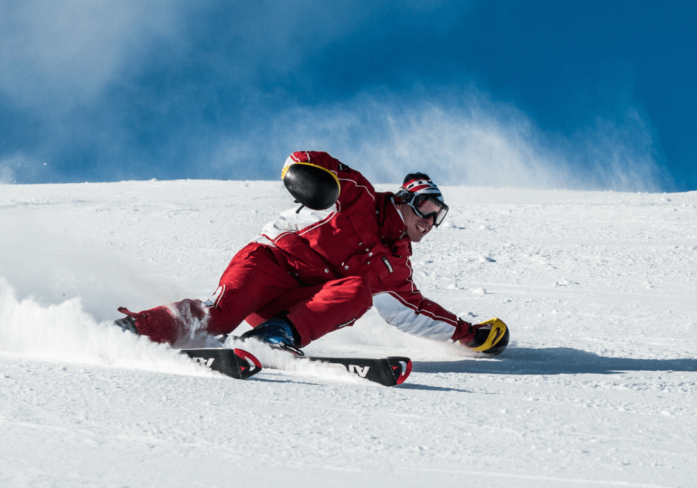 a snowboarder wearing snowboard gear and snowboarding on the snow