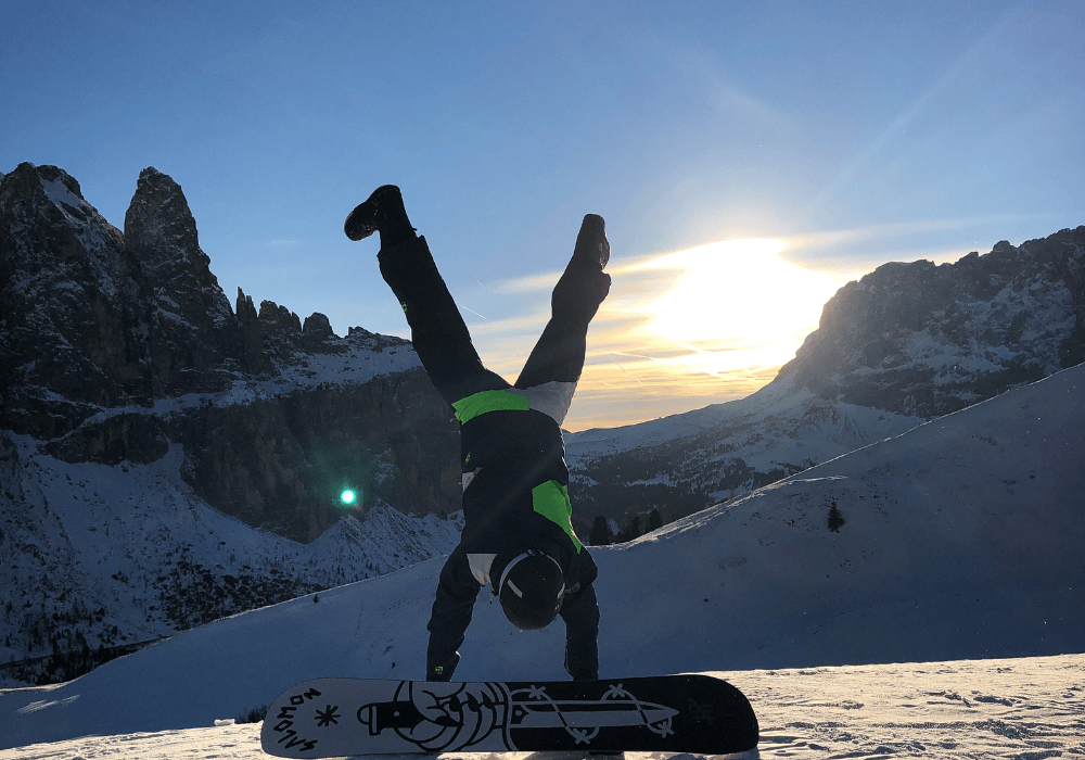 A snowboarder doing wheelie wearing womens snowboard boots